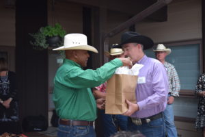 Mayor Collins handing General Cotton a gift.