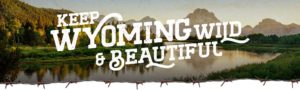 "Keep Wyoming Wild & Beautiful" with lake behind it.