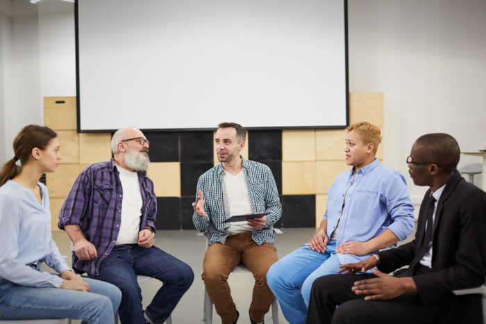 People sitting in a circle talking.