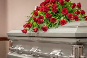 Silver coffin with red flowers.