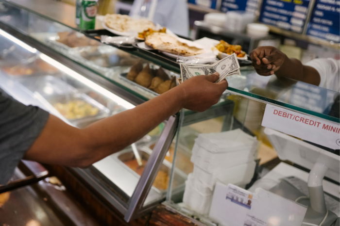 Person paying in cash.