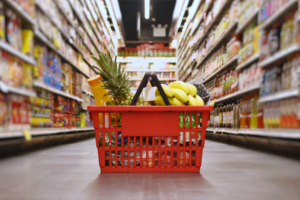 Grocery basket sitting in an aisle.