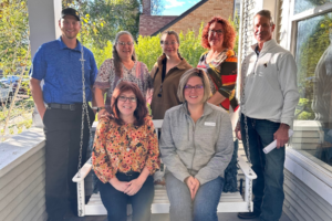 Attendees at the Java with the Chamber at Safe House on a porch.