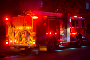 Firetruck with its lights on at nights.