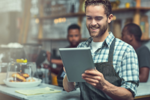 Man using a tablet in a bakery.