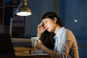 Person sleeping at her desk.