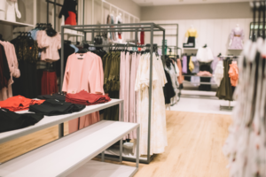 Clothes hanging in a retail store.