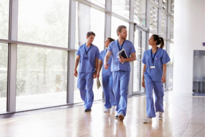 Healthcare workers walking down a hallway.