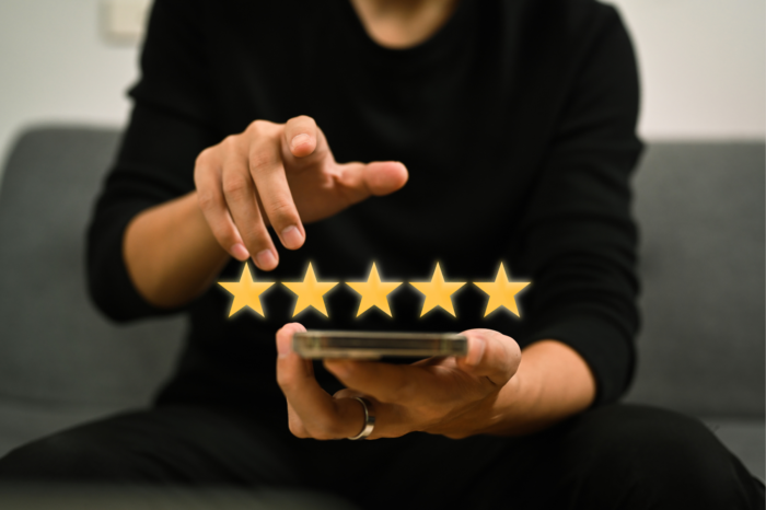 Man using his phone with 5 gold stars above.