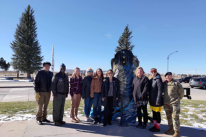 Military leaders and community members in front of the F.E. Warren Big Boot.