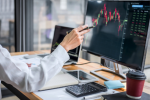 Man looking at stocks on his computer.