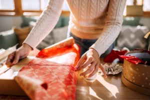 Woman wrapping a Christmas gift.