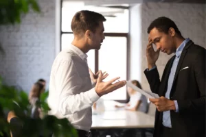 Two men arguing in an office.