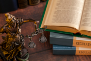 Scales and regulatory law books on a desk.