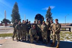 F.E. Warren members standing in front of a big boot.