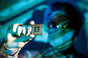 Scientist looking at a microchip.