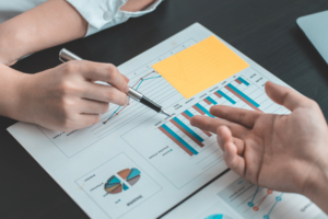 People looking over charts on a table.