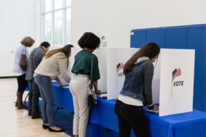 People in voting booths.