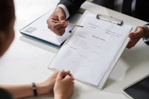 Man signing a contract.