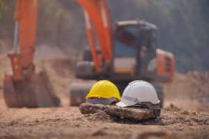 Hard hats in front of construction equipment.