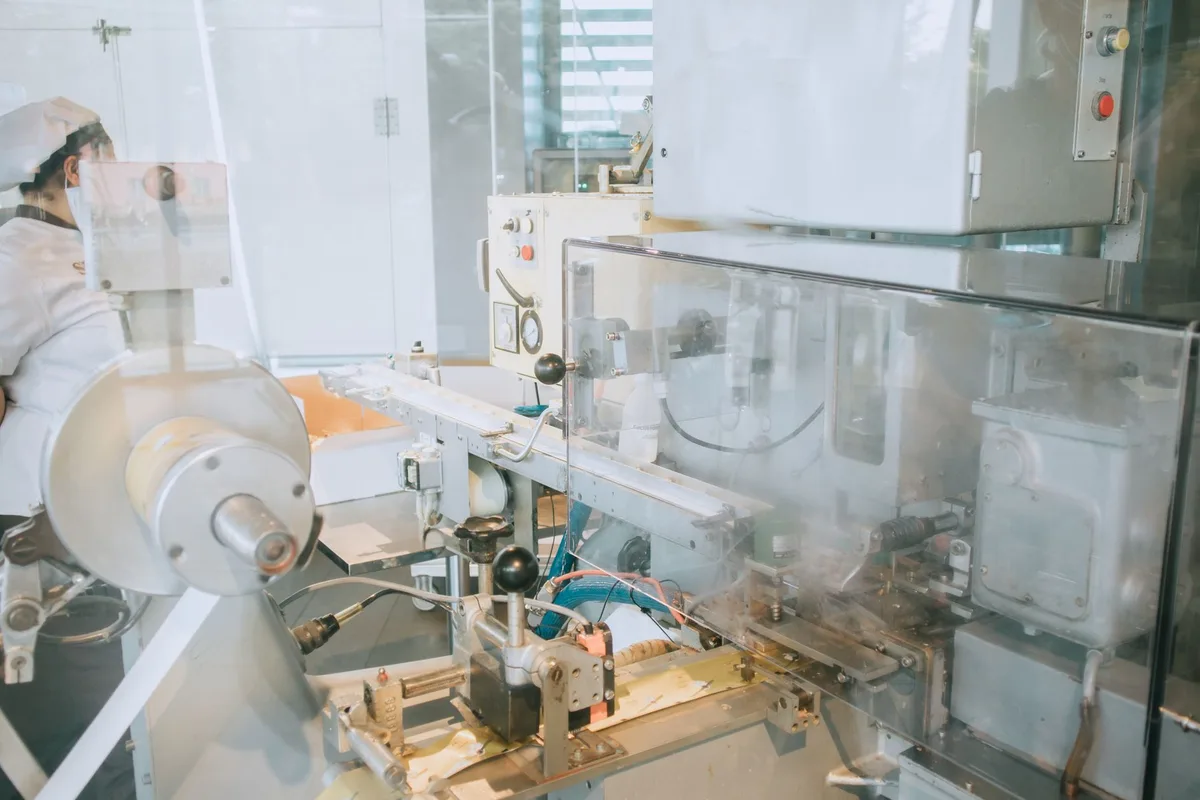 Workers assembling solar panels on a manufacturing production line