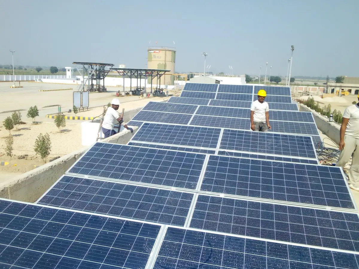 Solar panels installed on an industrial manufacturing facility rooftop in daylight