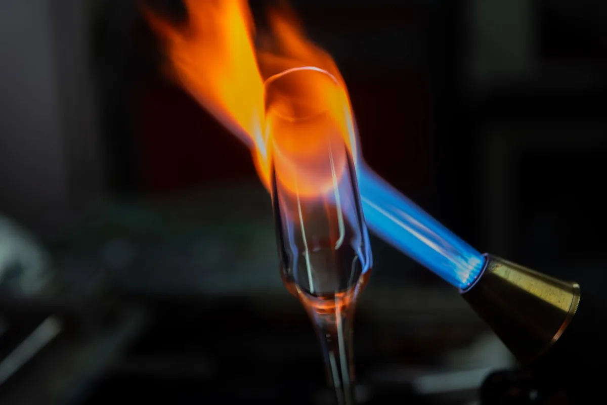 Handheld blowtorch producing an intensely hot blue flame capable of causing severe burns.