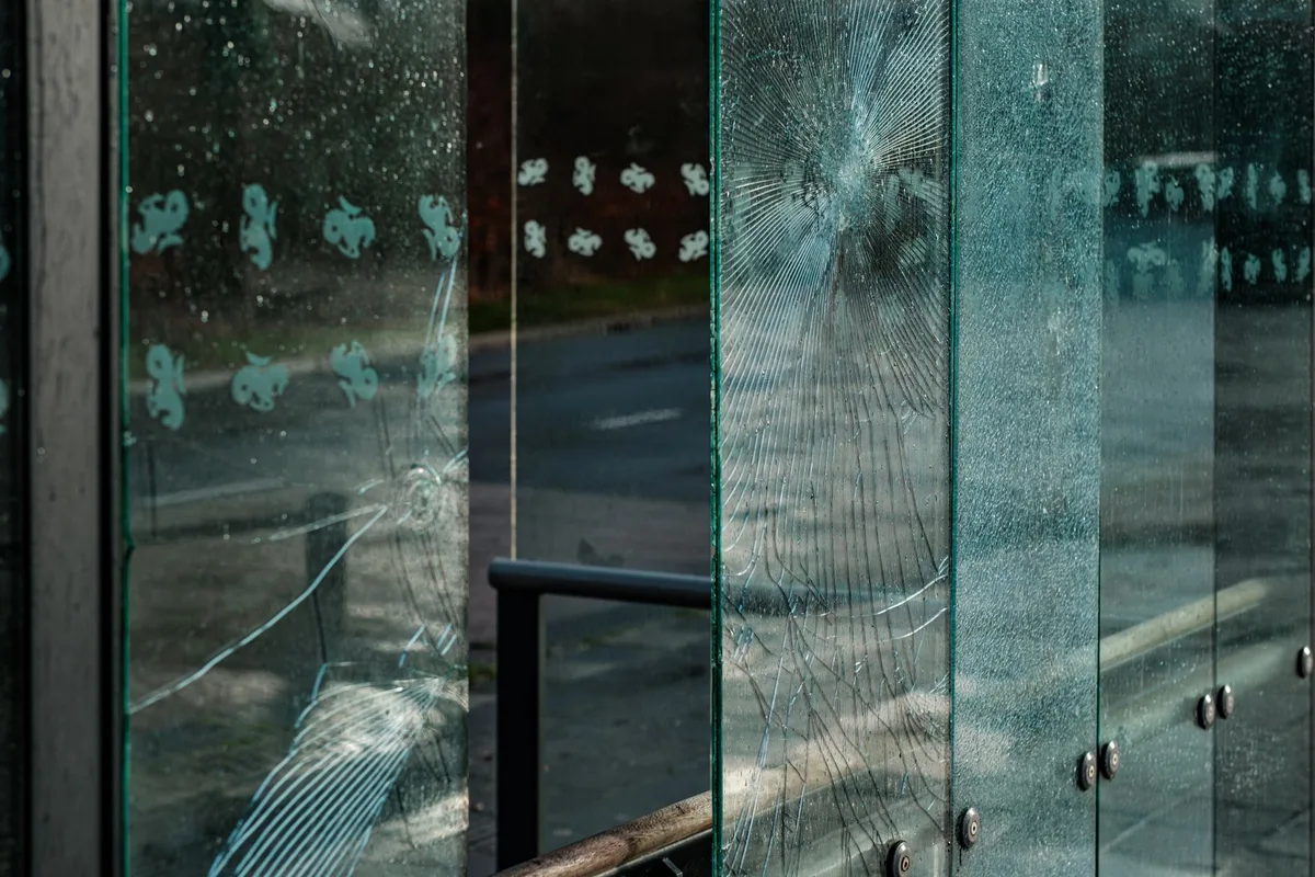 Vandalized car with scratches and damage in a parking lot