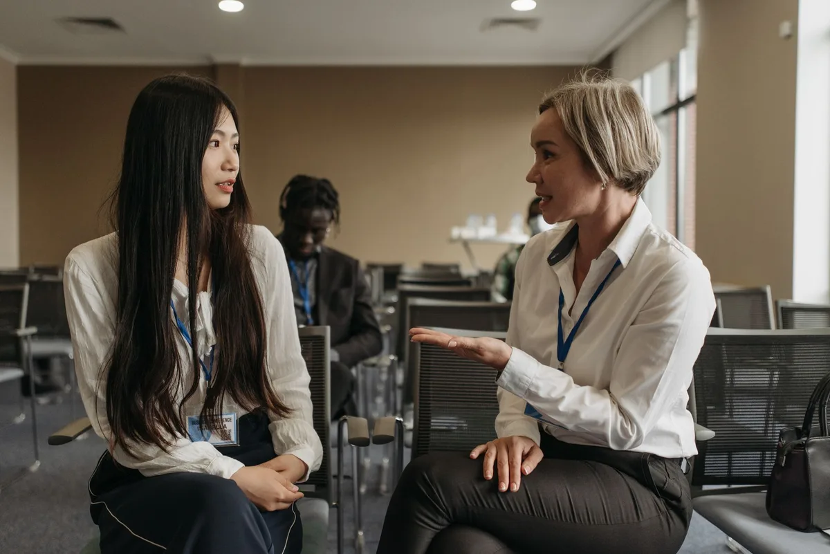 Two professionals discussing plans in a modern office setting