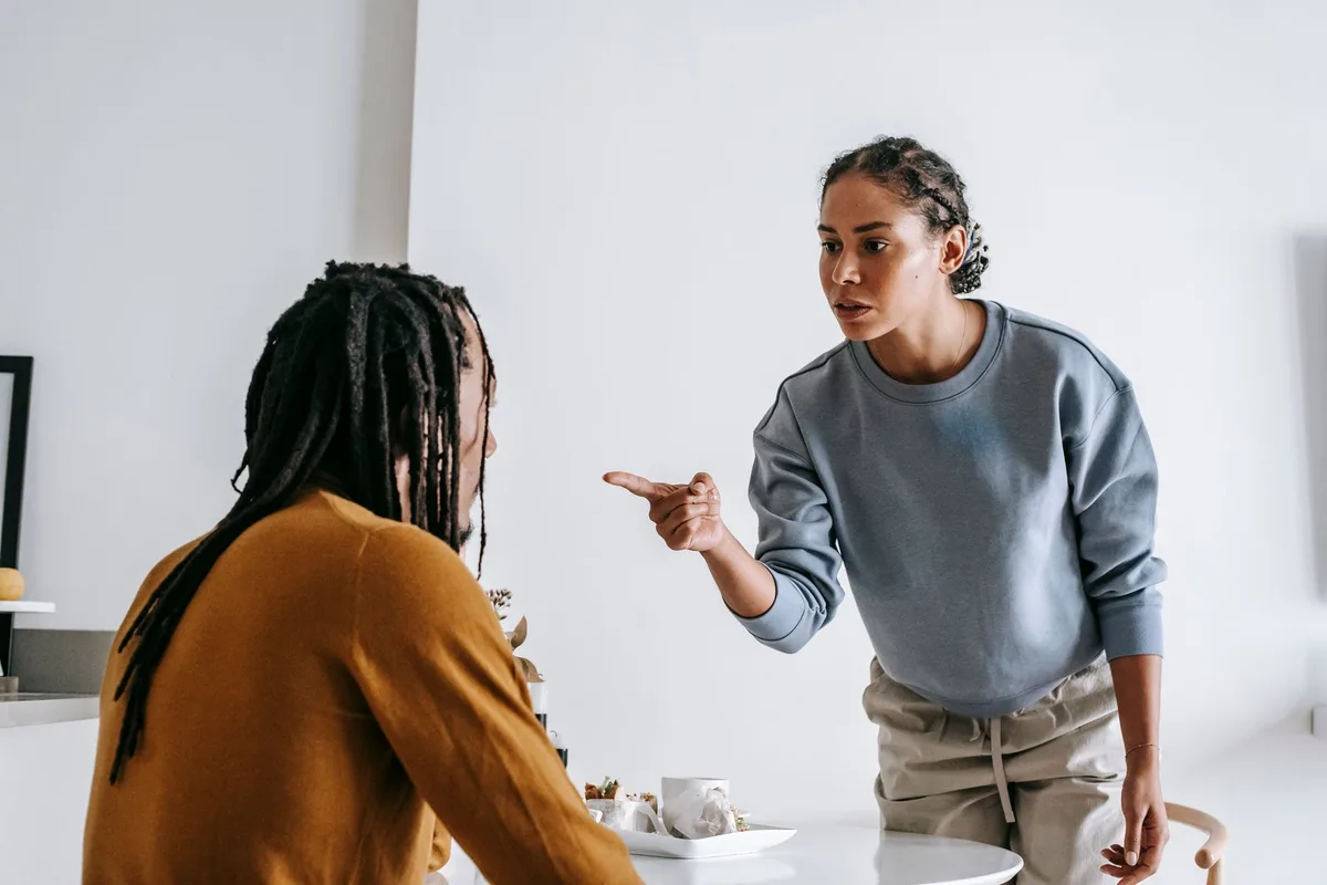 Two people in conversation, one person establishing a boundary