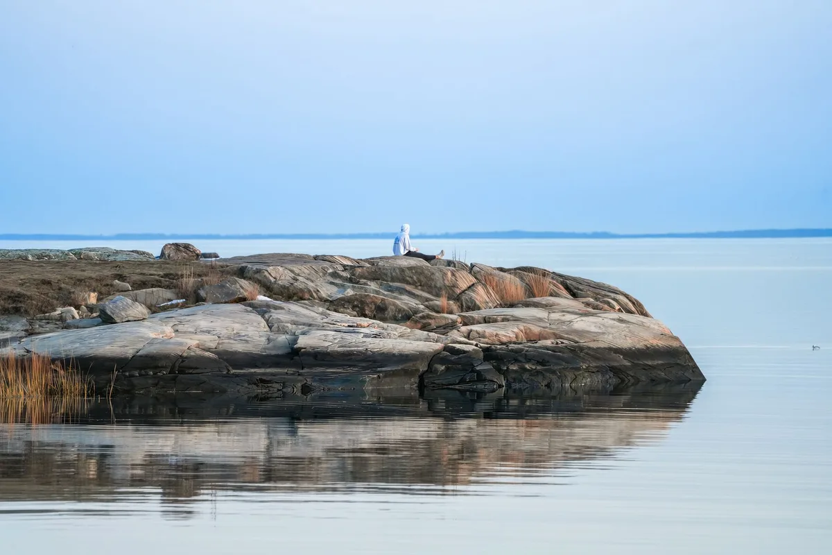 Person in a quiet space in a meditative pose, finding inner calm