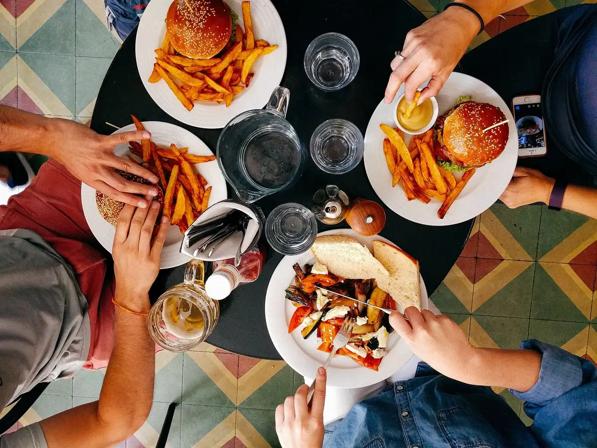 People dining together at a restaurant table enjoying a meal.