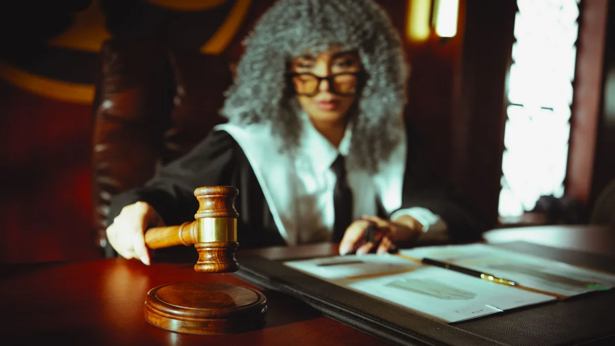 Gavel and legal documents on courtroom desk