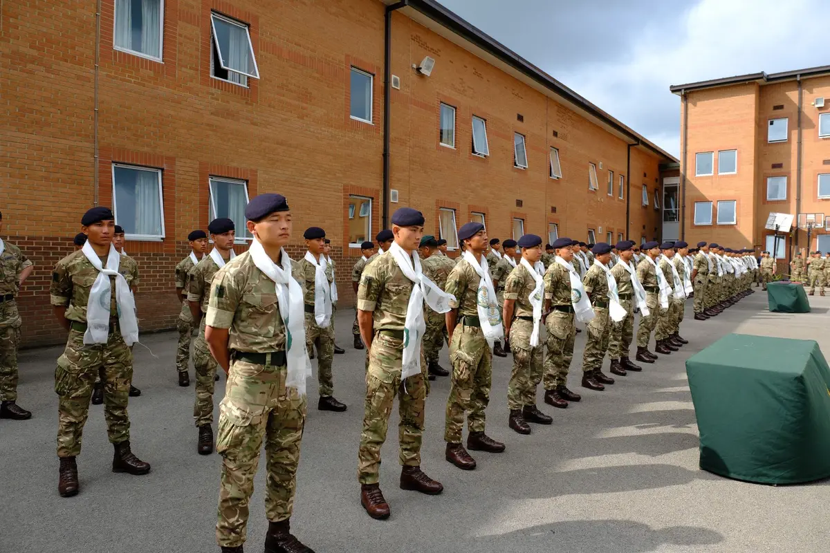 Uniformed service members in formation near a government building, representing federal military deployment in an urban