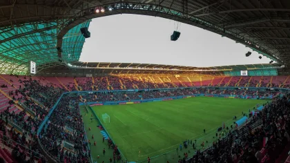 International stadium crowd watching a football match, illustrating global expansion debate