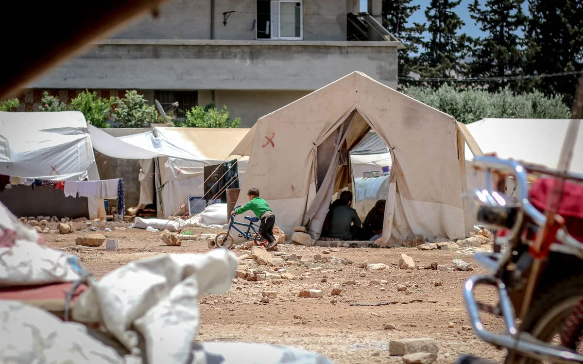Displaced families receiving aid and shelter after losing their homes in the strike