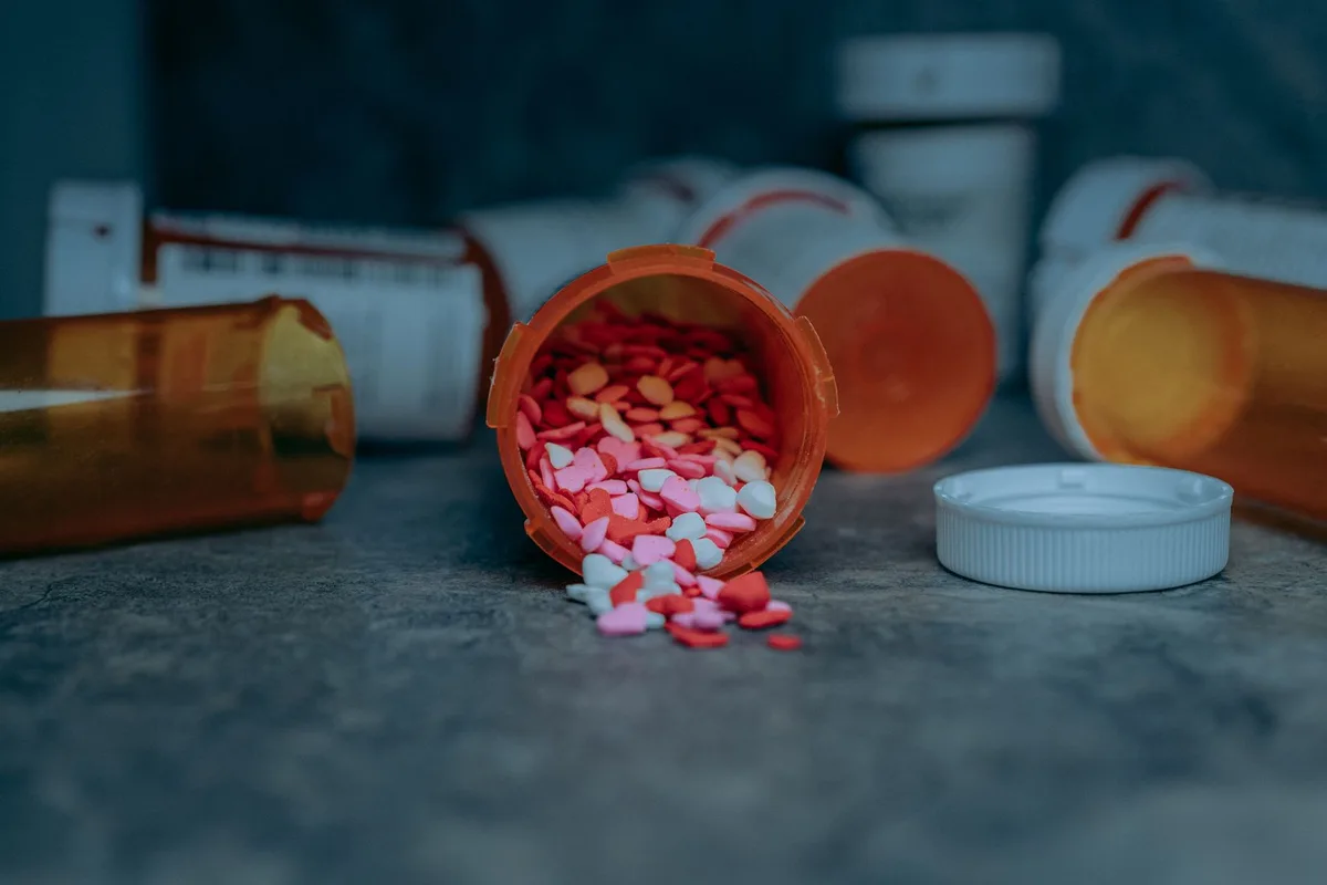 Close-up of prescription medication bottles and pills representing essential medical care