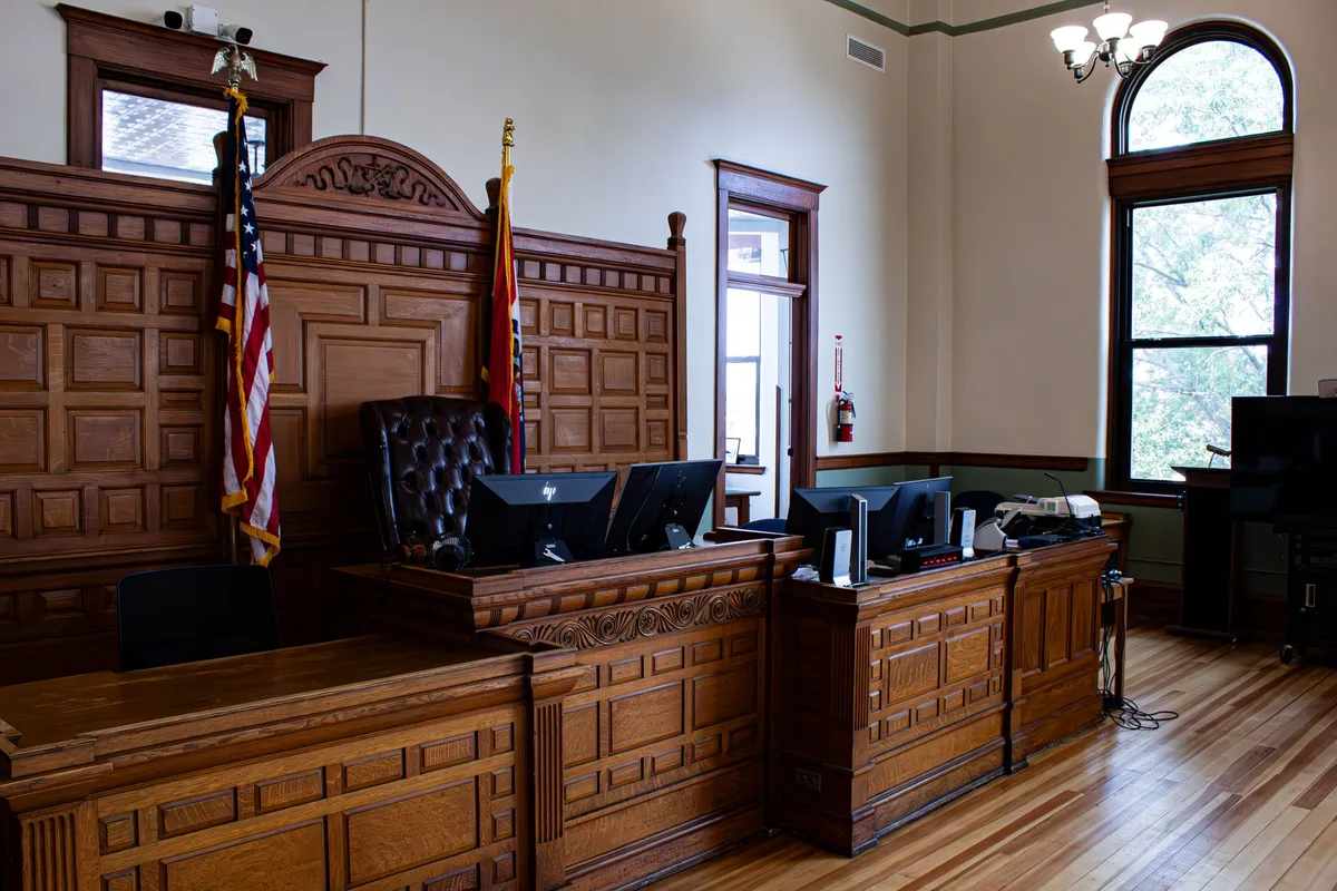 Courtroom interior with judge's bench and gavel symbolizing judicial oversight