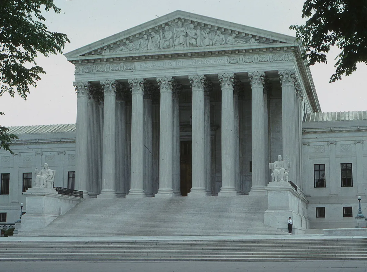 Interior of a federal courthouse with legal proceedings and architectural details