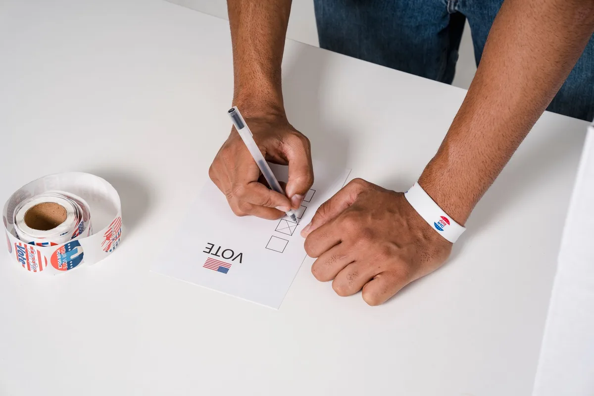 Ballot papers and voting materials on a desk with legislative documents