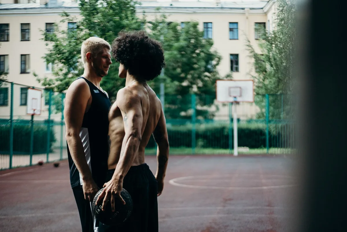 Two basketball players in an intense on-court confrontation during a game.