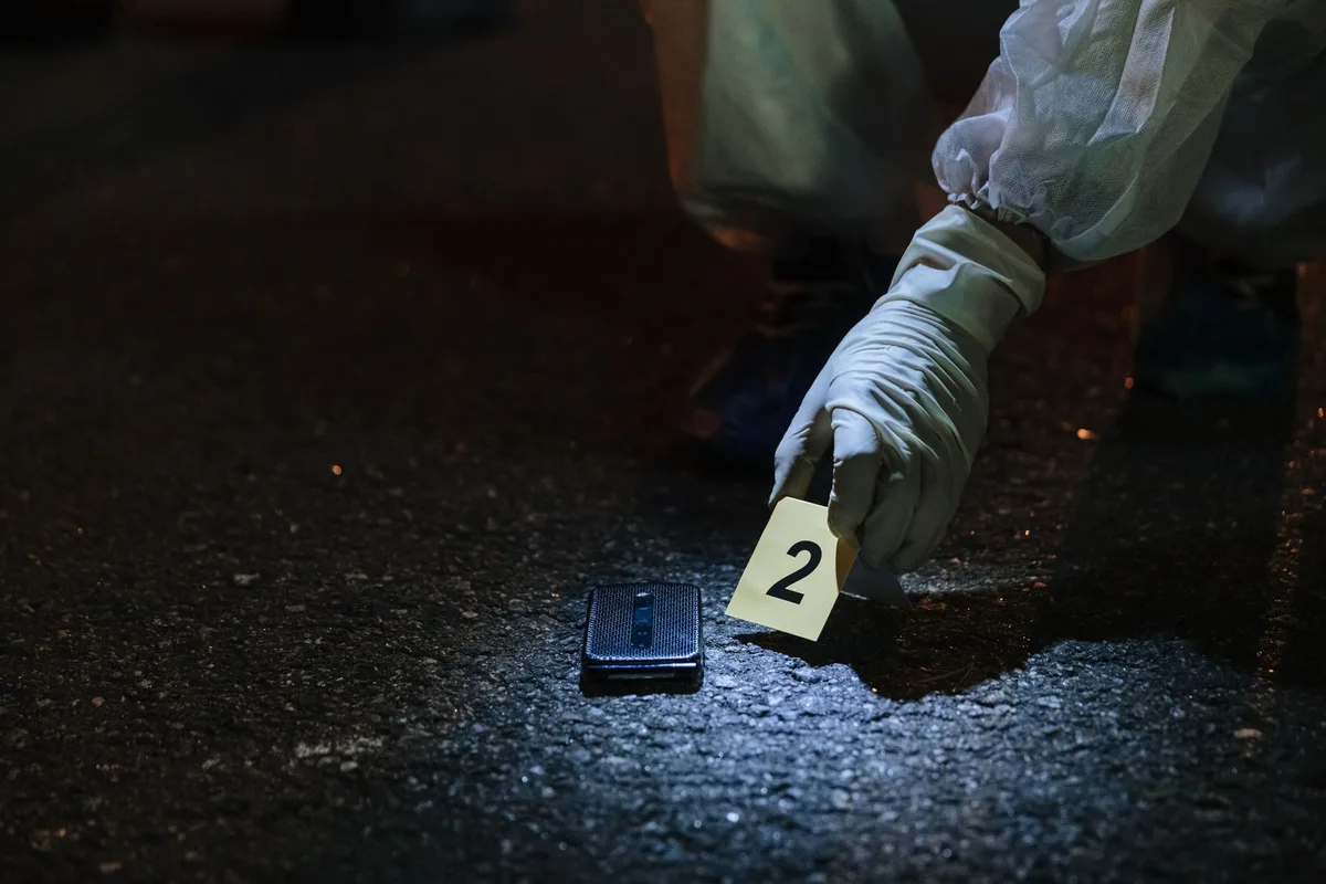 Forensic analyst examining smartphone data recovery using specialized tools and equipment