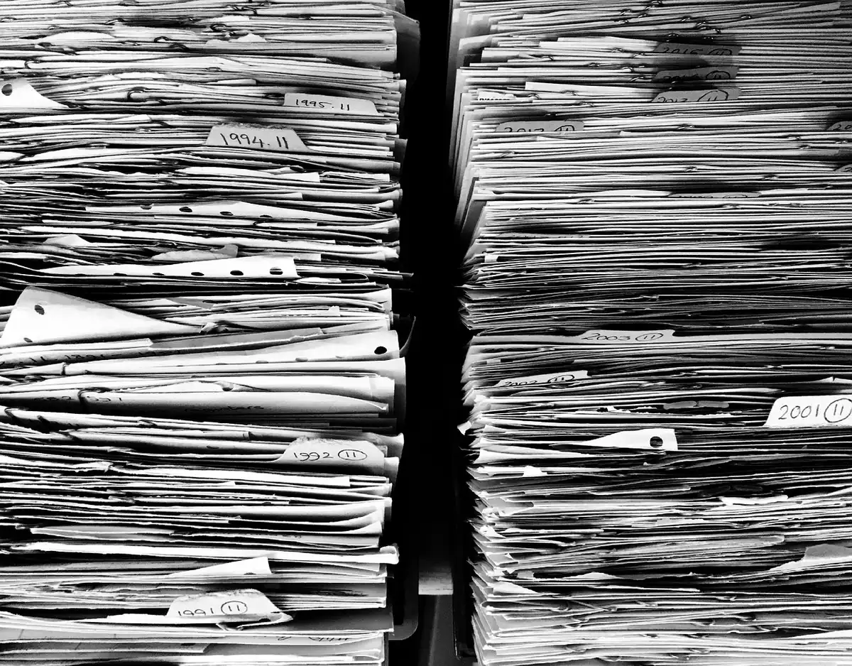 Stacked government documents and official records representing DOJ chronology evidence