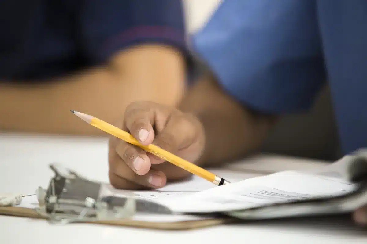 Close-up of hands comparing two different documents to illustrate record mismatches