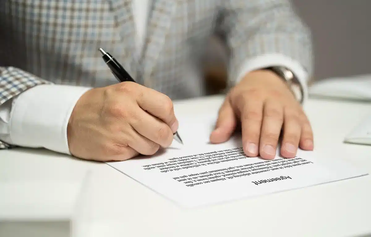 Hands pointing at a printed arrest log on a table