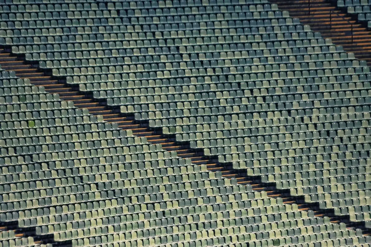 Batting practice cage with nets at an empty stadium, signaling a player preparing to return