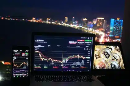 Trading floor with market data screens and financial charts displayed on monitors