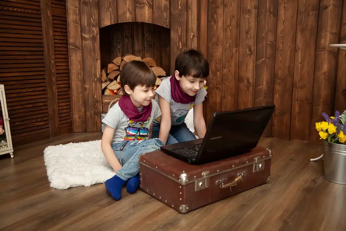 Children playing video games in a living room with a game console visible