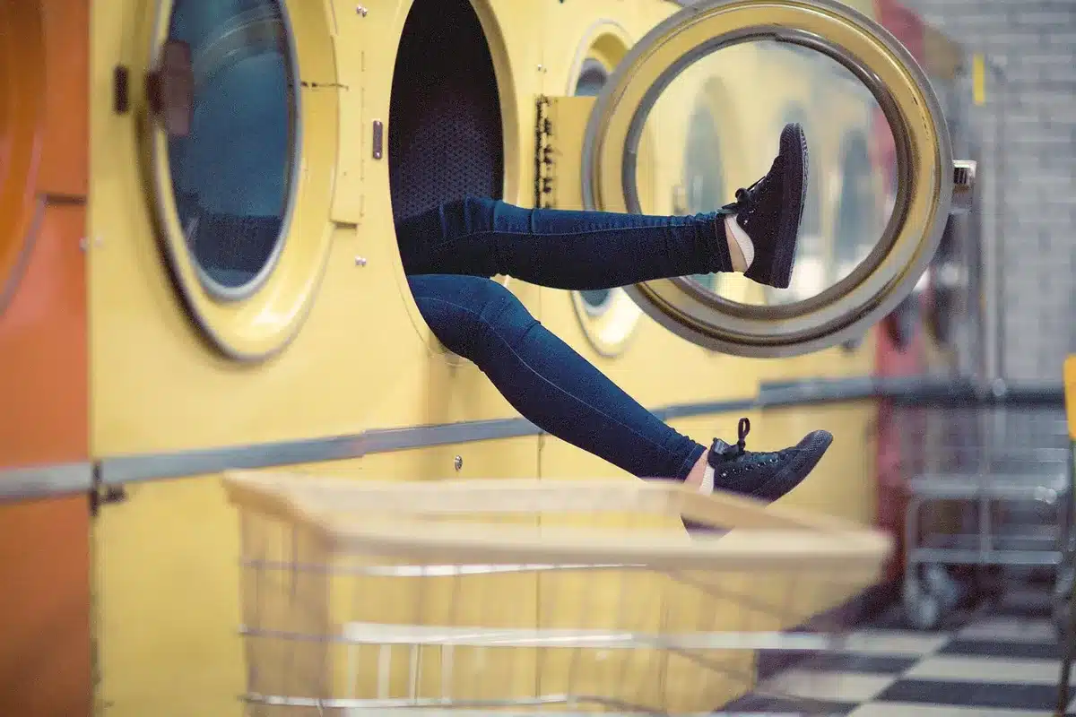 Person washing feet in a shower focusing on lower body hygiene