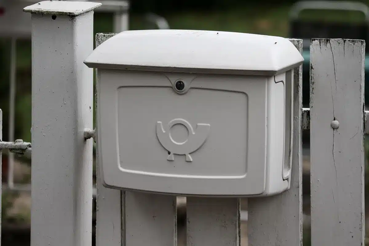 Unbranded ballot drop box with envelopes nearby on a table